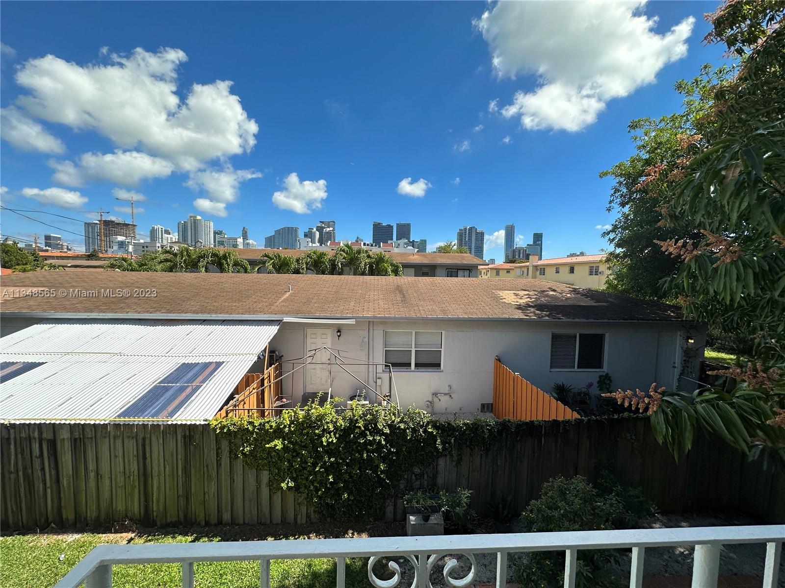 680 Southwest 10th Street, Unit 7 Miami, FL 33130 - Photo 32 of 34 a view of a house with a yard and potted plants
