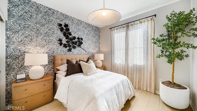 a bedroom with a bed and a potted plant