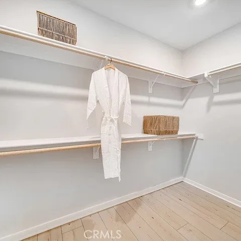 a view of walk in closet with clothes