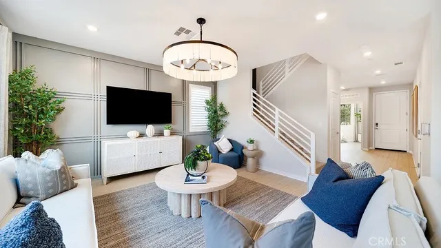 a living room with furniture a flat screen tv and a large window
