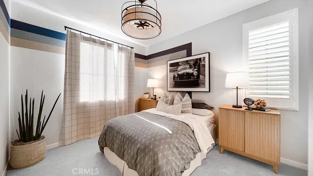 a bedroom with a bed and a television