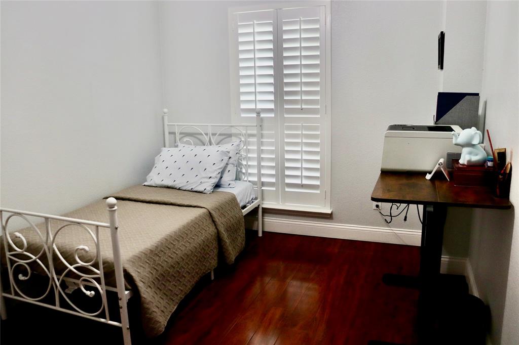 7916 Country Ridge Lane Plano, TX 75024 - Photo 11 of 27 a bedroom with a bed and a window