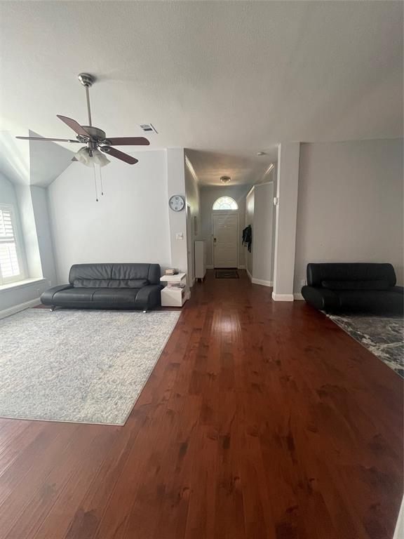 7916 Country Ridge Lane Plano, TX 75024 - Photo 14 of 27 a view of a room with a ceiling fan and wooden floor