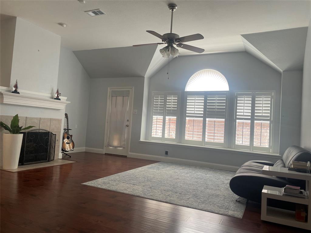 7916 Country Ridge Lane Plano, TX 75024 - Photo 22 of 27 a living room with furniture and a fireplace