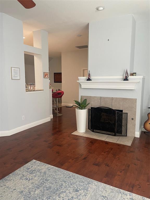 7916 Country Ridge Lane Plano, TX 75024 - Photo 25 of 27 a living room with a fireplace and a fireplace