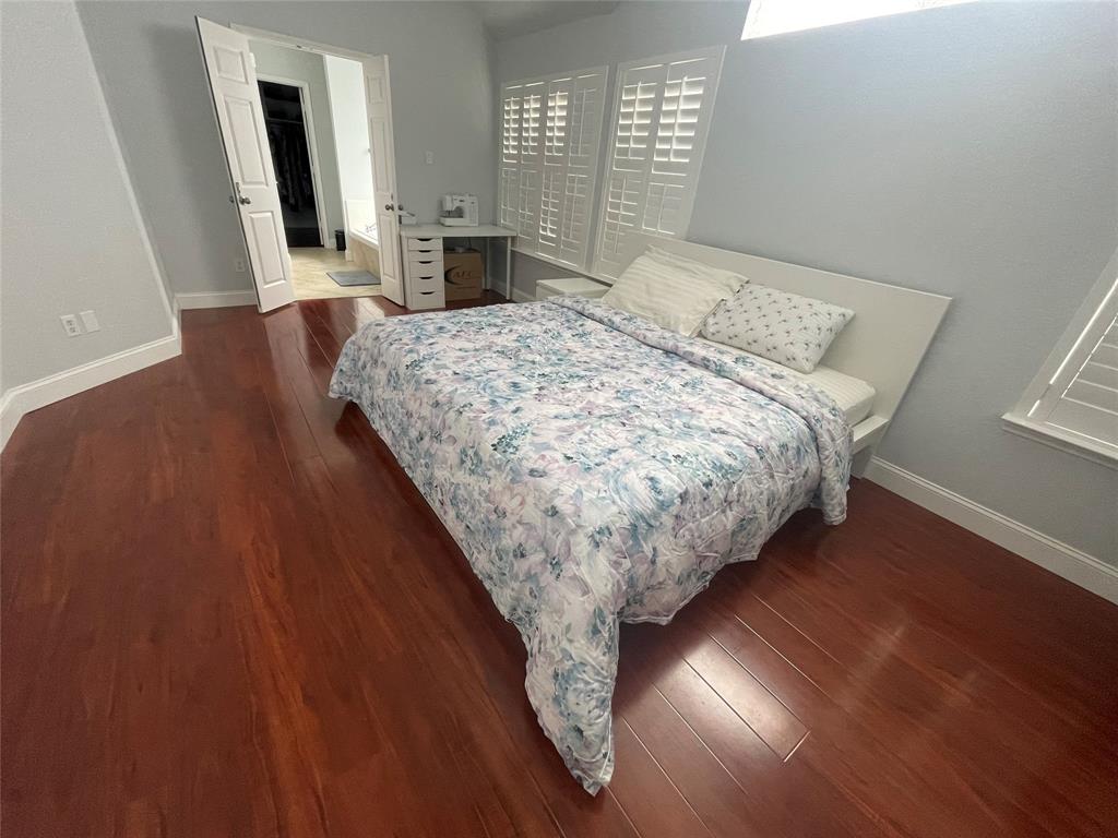 7916 Country Ridge Lane Plano, TX 75024 - Photo 3 of 27 a bed sitting in a spacious bedroom next to a window