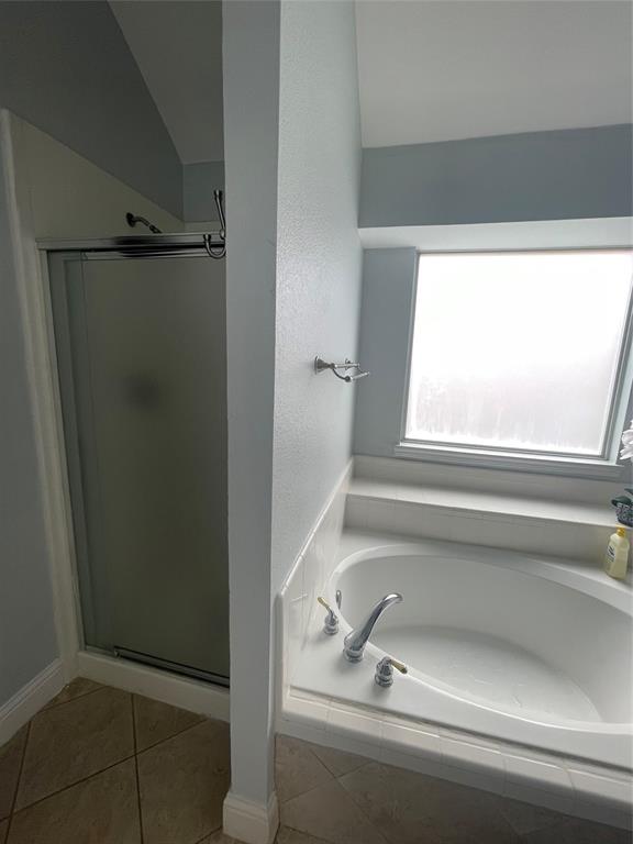 7916 Country Ridge Lane Plano, TX 75024 - Photo 5 of 27 a bathroom with a tub and mirror