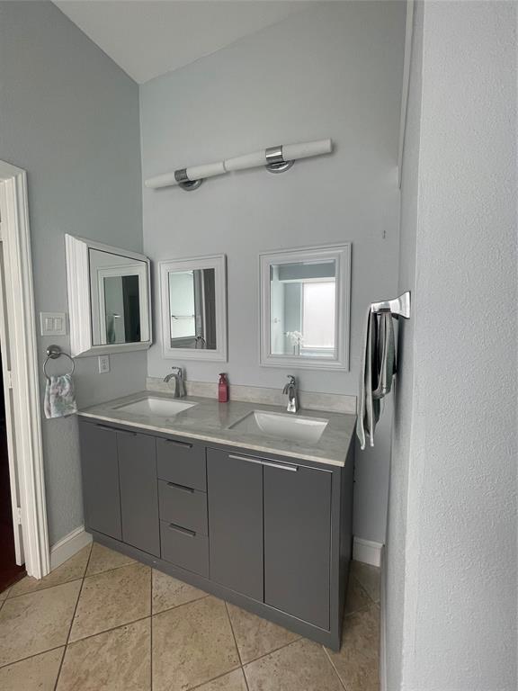 7916 Country Ridge Lane Plano, TX 75024 - Photo 6 of 27 a bathroom with a double vanity sink and mirror