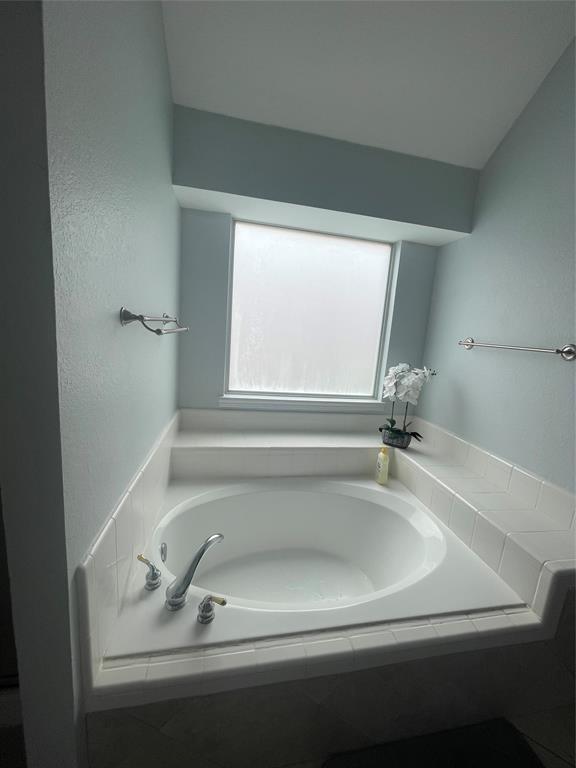 7916 Country Ridge Lane Plano, TX 75024 - Photo 7 of 27 a bathroom with a tub sink and mirror