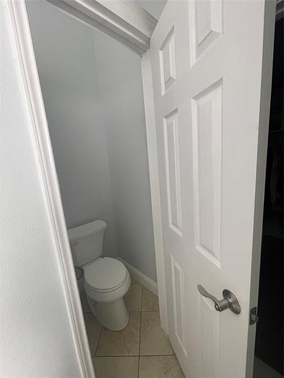 7916 Country Ridge Lane Plano, TX 75024 - Photo 8 of 27 a white toilet sitting next to a white cabinet