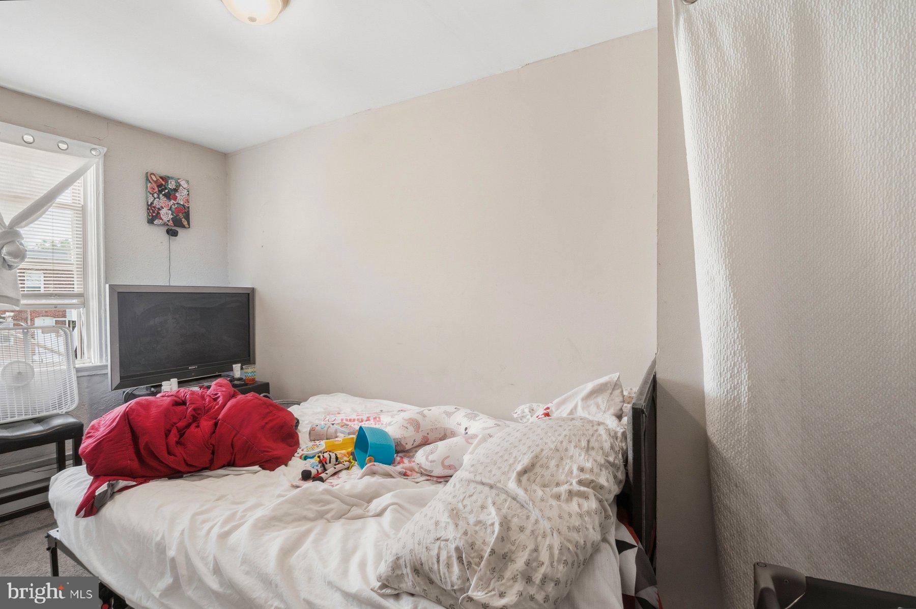 4931 Brookwood Road Baltimore, MD 21225 - Photo 20 of 25 a bedroom with a bed and a fireplace