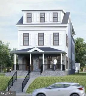 front view of a brick house with a yard