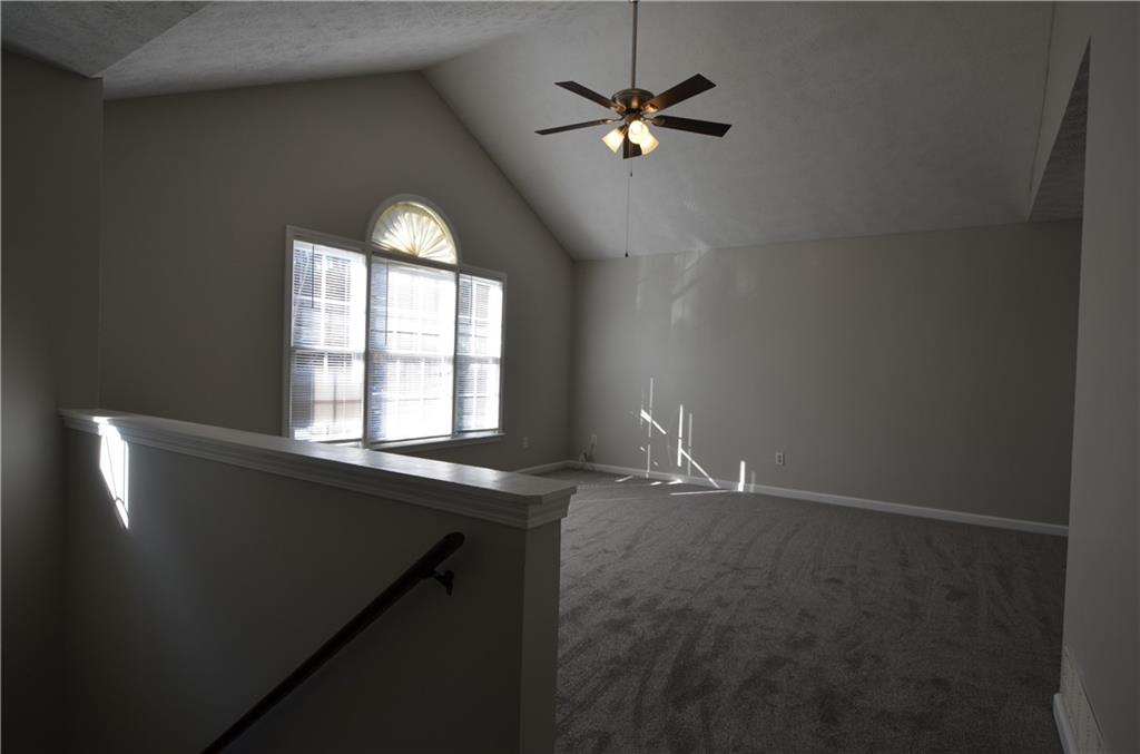140 Stewart Drive Dallas, GA 30132 - Photo 2 of 21 an empty room with windows and fan