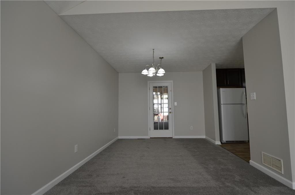 140 Stewart Drive Dallas, GA 30132 - Photo 4 of 21 wooden floor in an empty room with a window