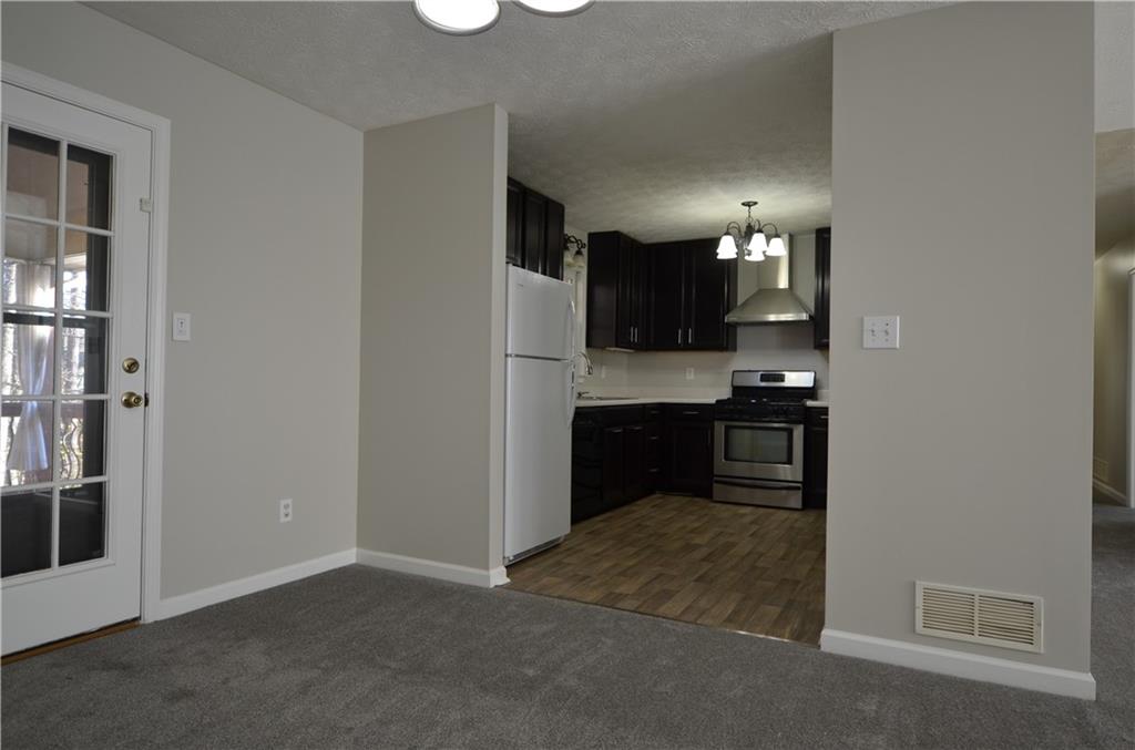 140 Stewart Drive Dallas, GA 30132 - Photo 5 of 21 a kitchen with granite countertop a refrigerator and a stove