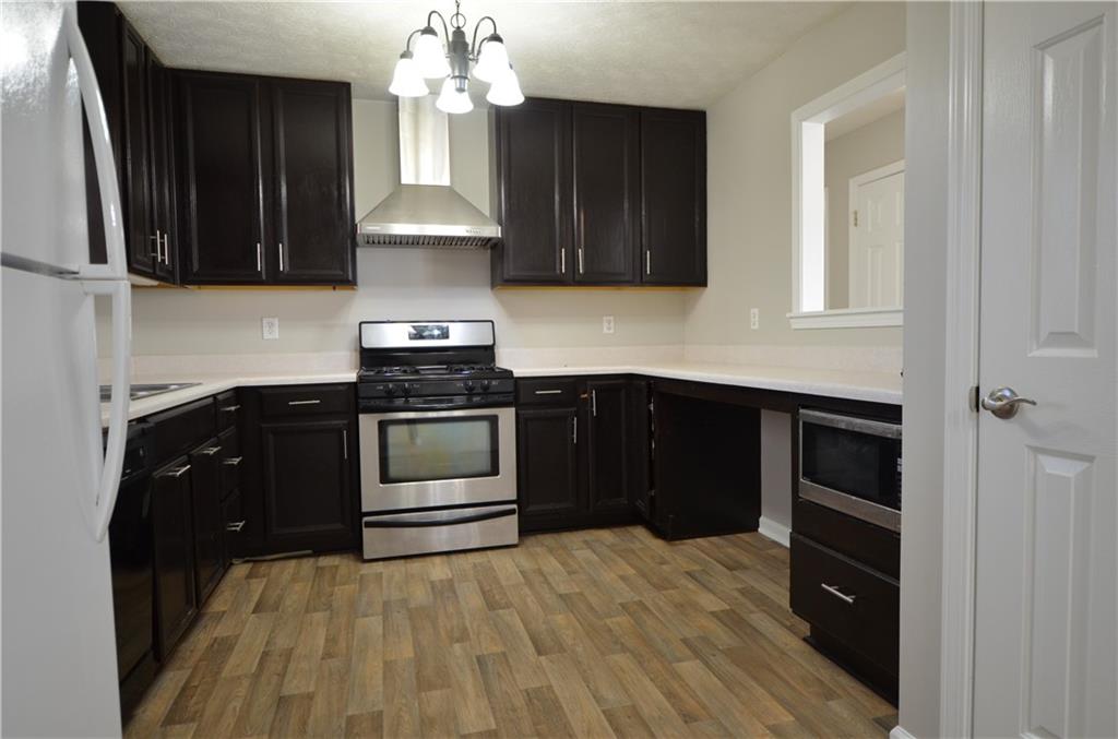 140 Stewart Drive Dallas, GA 30132 - Photo 7 of 21 a kitchen with a stove and a microwave