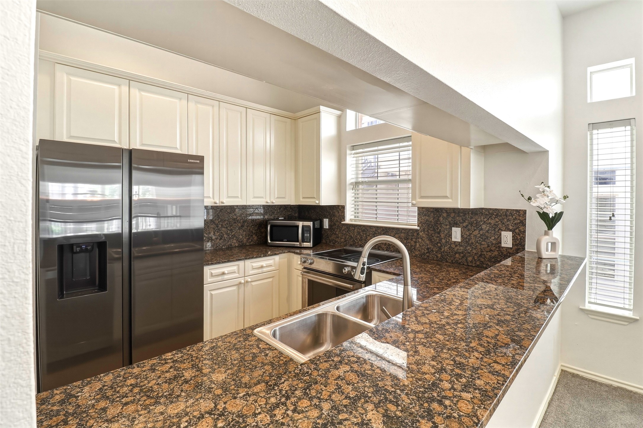 2918 Ranch Road 620, Unit 265 Austin, TX 78734 - Photo 11 of 40 Granite counters and white cabinetry define this well-appointed kitchen.
