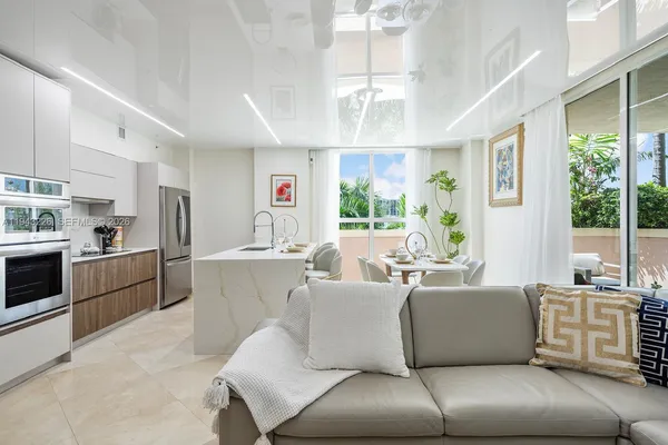 a living room with furniture and a potted plant