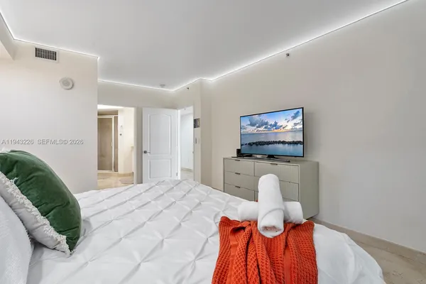 a bedroom with a bed and a couch