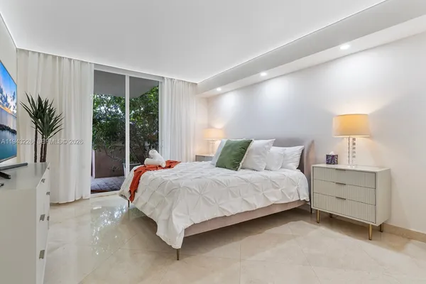 a bedroom with a bed and a large window