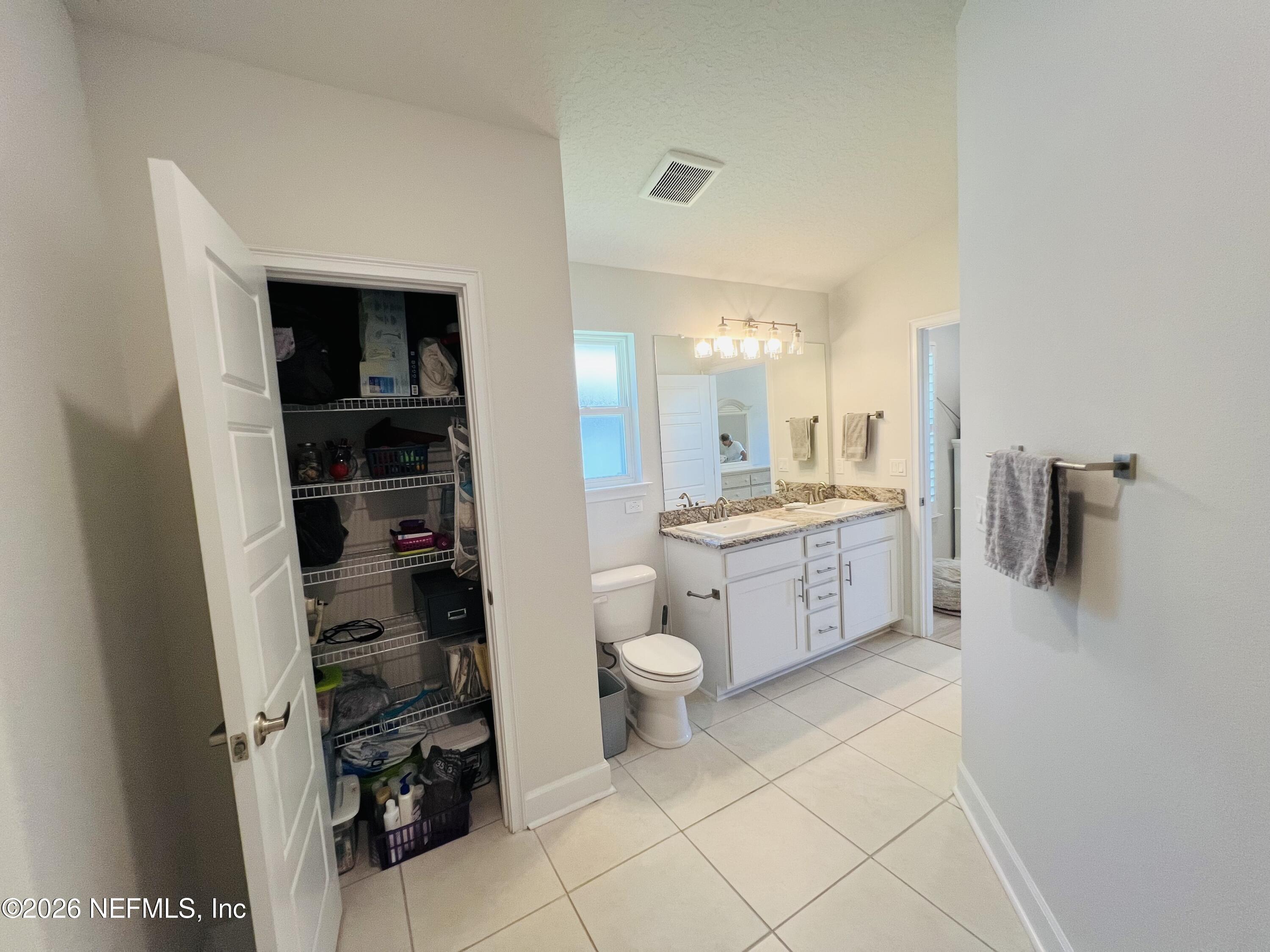 2 Rivertown Road Palm Coast, FL 32137 - Photo 73 of 80 a large bathroom with a double vanity sink toilet and shower