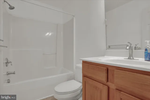 a bathroom with a granite countertop sink toilet and bathtub