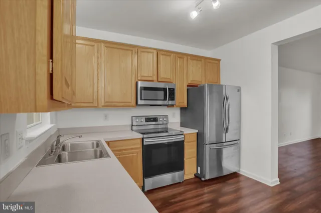 a kitchen with a refrigerator sink and microwave