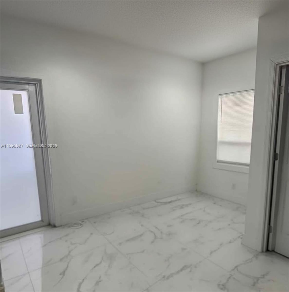 11417 Southwest 35th Lane Miami, FL 33165 - Photo 12 of 18 an empty room with windows