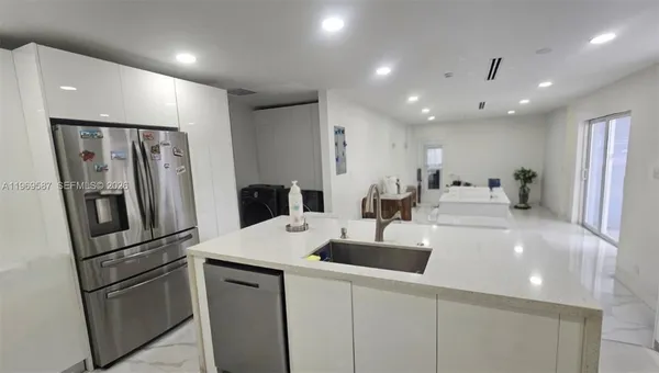 a bathroom with a white tub shower and sink