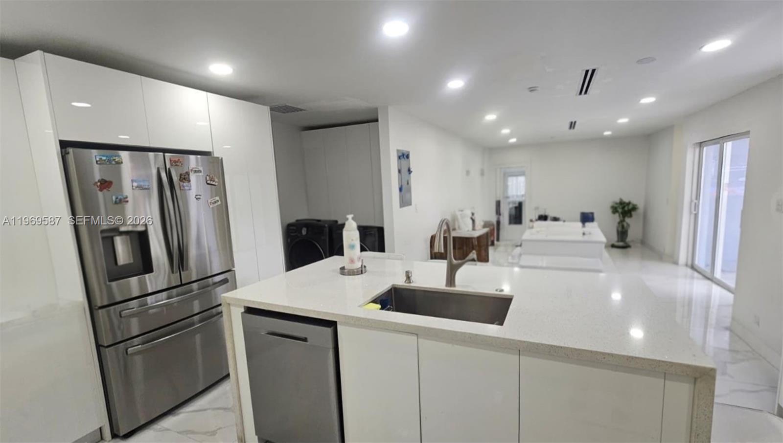 11417 Southwest 35th Lane Miami, FL 33165 - Photo 3 of 18 a kitchen with stainless steel appliances a refrigerator sink and microwave