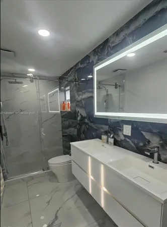 a view of a patio with table and chairs potted plants and palm tree