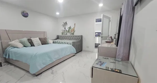 a bedroom with a bed and a couch