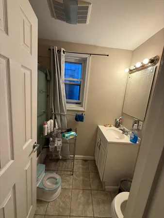 a bathroom with a sink toilet and mirror