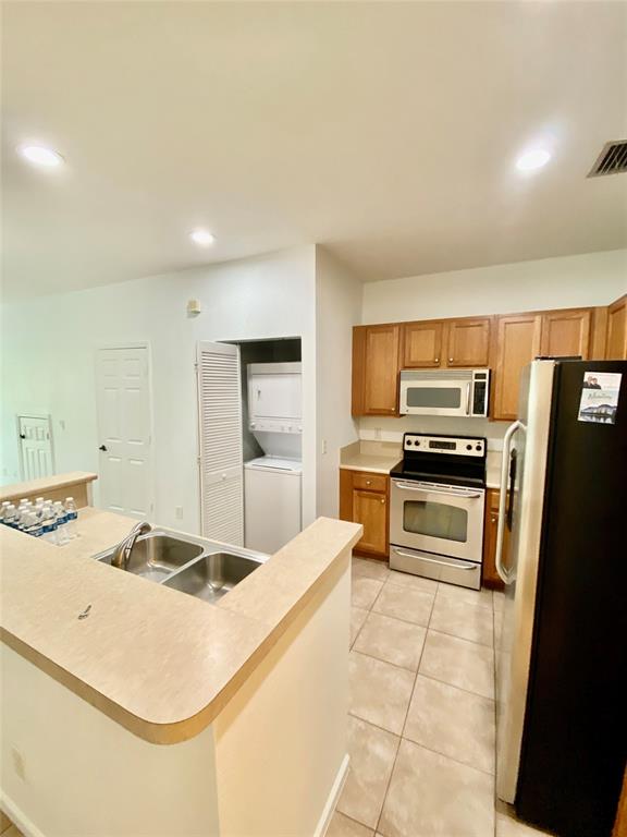 8720 Cypress Walk Court, Unit 8720 Tamarac, FL 33321 - Photo 11 of 36 a kitchen with kitchen island a sink appliances and cabinets