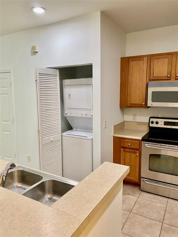8720 Cypress Walk Court, Unit 8720 Tamarac, FL 33321 - Photo 15 of 36 a kitchen with a stove sink and cabinets