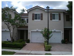 8720 Cypress Walk Court, Unit 8720 Tamarac, FL 33321 - Photo 2 of 36 a front view of a house with garden
