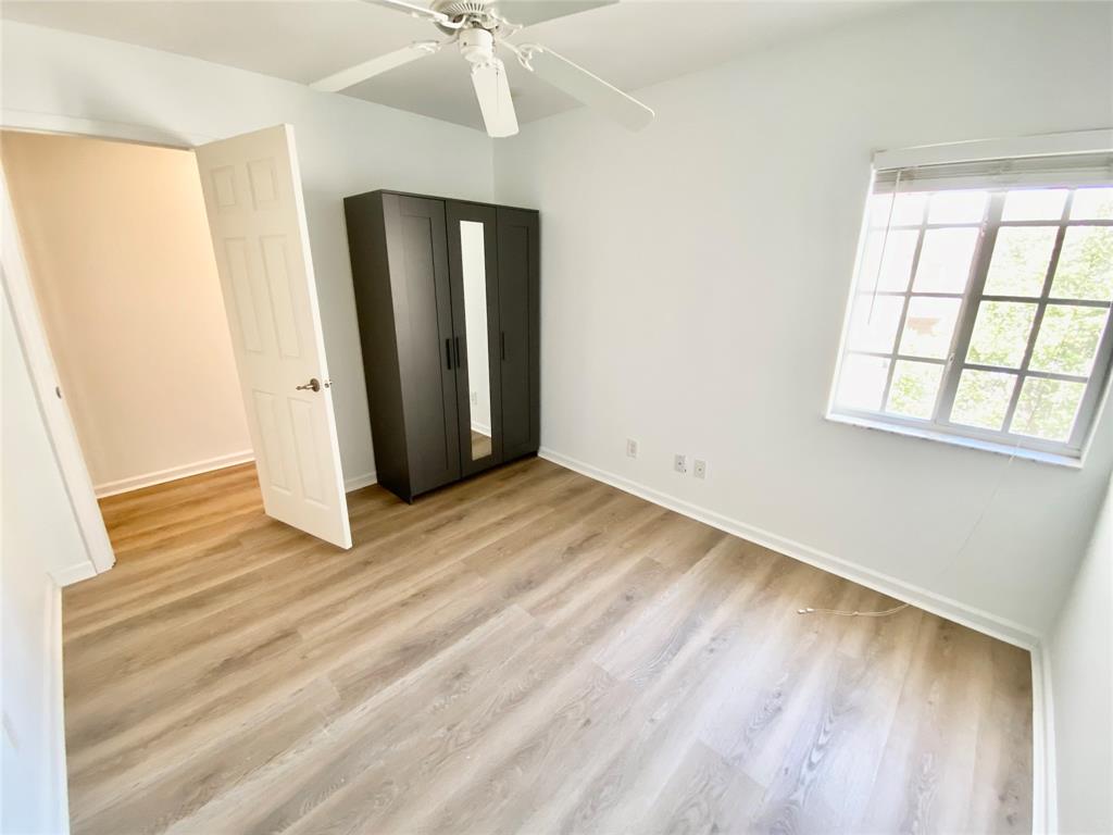 8720 Cypress Walk Court, Unit 8720 Tamarac, FL 33321 - Photo 28 of 36 a view of an empty room with wooden floor and a window