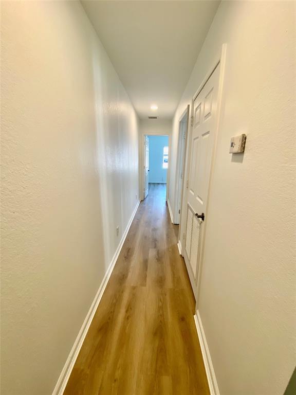8720 Cypress Walk Court, Unit 8720 Tamarac, FL 33321 - Photo 32 of 36 a view of a hallway with wooden floor