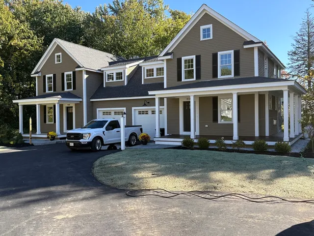 a front view of a house with a yard table and chairs