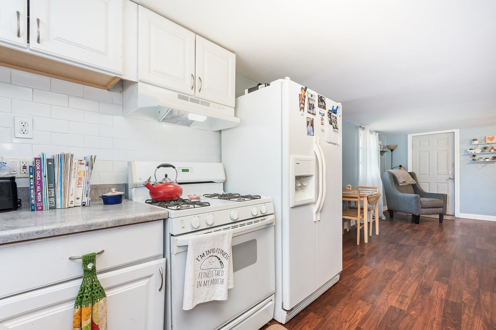 341 West Kennedy Road Braidwood, IL 60408 - Photo 8 of 15 a kitchen with stainless steel appliances a white refrigerator a sink dishwasher and white cabinets with wooden floor