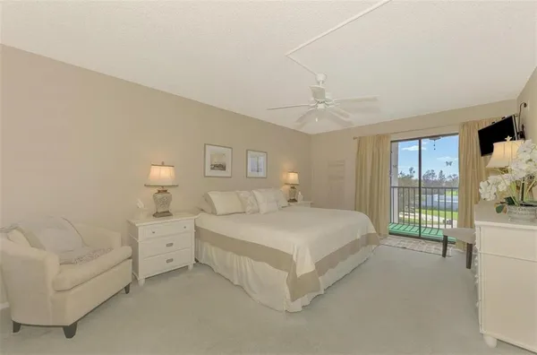 a spacious bedroom with a bed and a large window