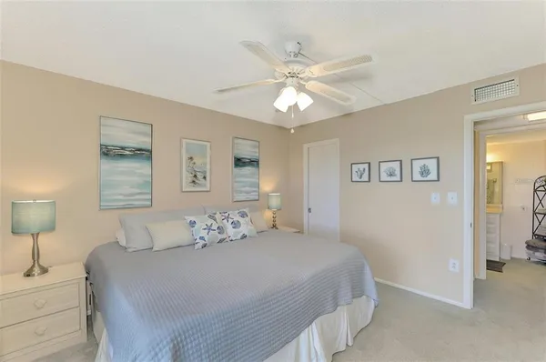 a bedroom with a bed and a lamp