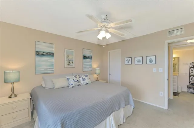 a bedroom with a bed and a lamp