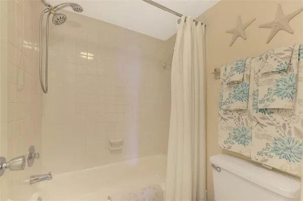 a bathroom with a shower and a sink