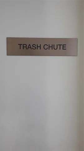 a bathroom with a toilet and a mirror