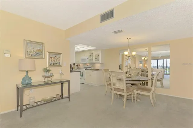 a dining room with furniture and a chandelier