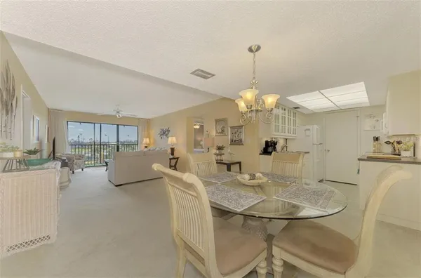a view of a dining room with furniture and a chandelier
