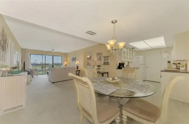 a view of a dining room with furniture and a chandelier