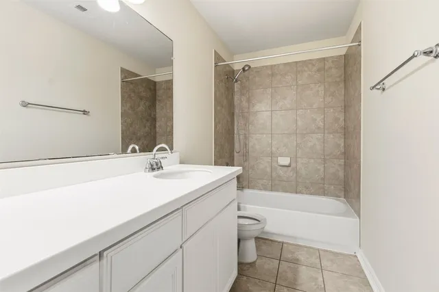 a bathroom with a sink mirror toilet and bathtub