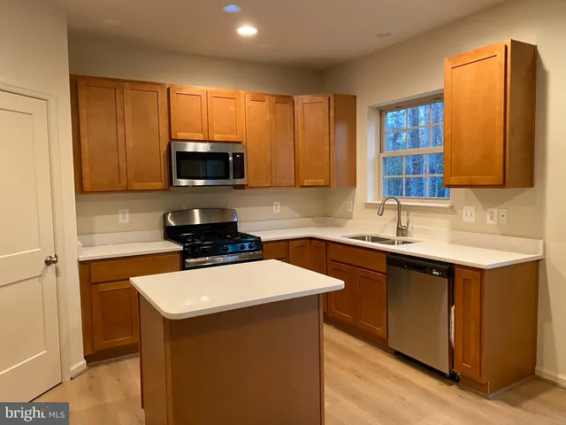 a kitchen with a sink stove and microwave